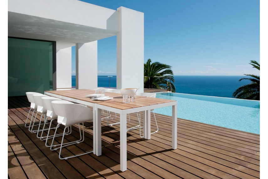 The chair is available in two designs: a stackable armchair or a chair with sled legs.