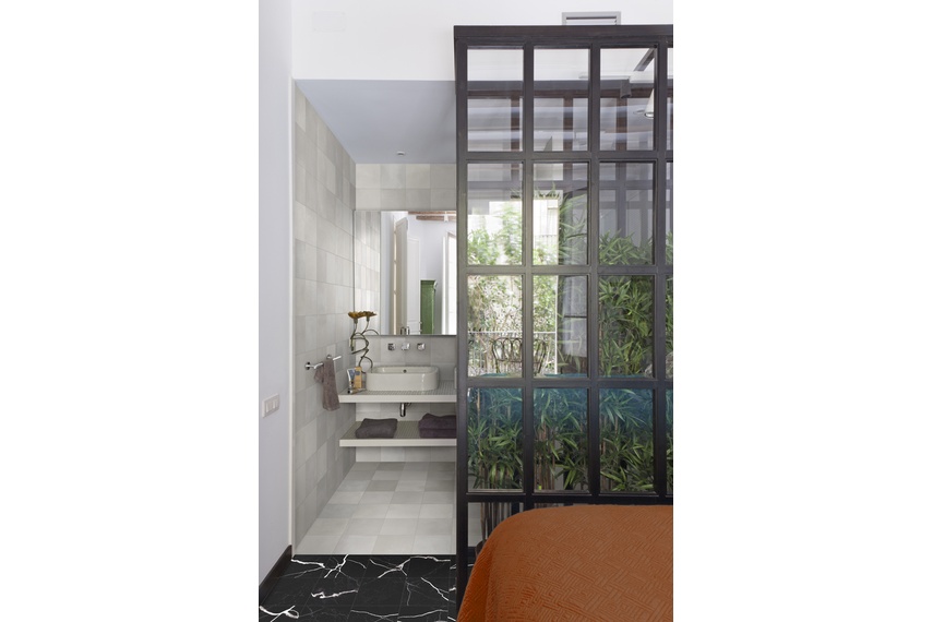 Marmo Nero Terra Grigio tiling in a 19.5 x 19.5 size.